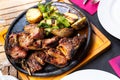 dinner served for two person of grilled beef tenderloin with potatoe and pepper in iron frying pan Royalty Free Stock Photo