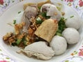 Hearty eating meal noodle with fish ball, fishcake slices and boiled pork for light breakfast or lunch focus on foreground with b