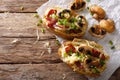 Hearty hot baked potatoes with bacon, mushrooms, onions and cheese close-up. Horizontal top view Royalty Free Stock Photo