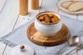 Hearty Irish stew of beef, potatoes and green peas in beer sauce in a ceramic pot on a light wooden background. Irish cuisine Royalty Free Stock Photo