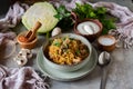 A hearty lunch for the whole family: cabbage stewed with vegetables and mushrooms in a beautiful place on a gray Royalty Free Stock Photo