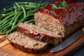 Hearty meatloaf made with ground beef, pork, and veal, served with a side of buttery garlic green beans