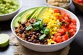 hearty quinoa bowl with added black beans, corn and salsa