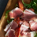 hearty snack in a restaurant with ham, salami, rocket and cheese