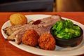 Hearty Southern BBQ Feast with Brisket and Hushpuppies in Restaurant Setting