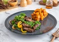 Hearty steak dinner with vegetables, fries, and salad on the side Royalty Free Stock Photo