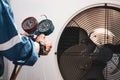 Heat and Air Conditioning, HVAC system service technician using measuring manifold gauge checking refrigerant and filling Royalty Free Stock Photo