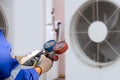 Heat and Air Conditioning, HVAC system service technician using measuring manifold gauge checking refrigerant and filling Royalty Free Stock Photo