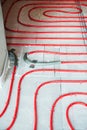 Heat floor instalation. Repair, engineering. Underfloor heating technology. Construction work, repair Royalty Free Stock Photo