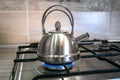 Heat metal kettle tea on gas, boiling water, top stove stainless Royalty Free Stock Photo