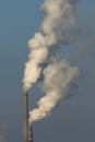 Heat station smoke stack against blue sky Royalty Free Stock Photo