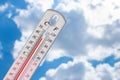 Heat, thermometer shows the temperature is hot in the sky, Summer Royalty Free Stock Photo