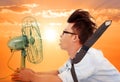 The heat wave is coming,business man holding a electric fan Royalty Free Stock Photo
