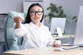 Heat in the workplace. A young Asian business woman sits in the office at the desk Royalty Free Stock Photo