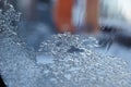 Heated windshield to melt the snow. Snow-covered car windshield with melted snow drops. Blurred background Royalty Free Stock Photo