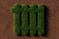 Heater symbol made from green grass on brown soil background, green heating or energy concept
