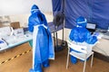 Heathcare worker in full personal protection equipment managing outdoor covid-19 testing center