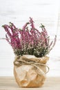 Heather bouquet on white wooden background