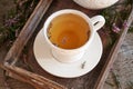 Heather tea in a white ceramic cup on a table Royalty Free Stock Photo
