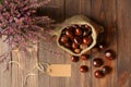 Heathers in ceramic pots, horse chestnuts in jute bag and tag