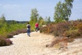 Heathland in National Park Maasduinen in the Netherlands - couple with their dog