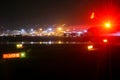 Heathrow airport tarmac on a rainy night with British Airways plane readying for takeoff and lights reflecting off wet surfaces - Royalty Free Stock Photo