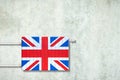 Heating battery, in the colors of the England flag on a concrete wall. Copy space. Raising heating prices. Heat saving