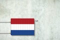 Heating battery, in the colors of the Netherlands flag on a concrete wall. Copy space. Raising heating prices. Heat