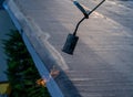 By heating the edge of the roof bitumen waterproofing with a gas burner