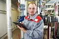 Heating engineer in boiler room Royalty Free Stock Photo