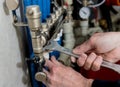 Heating engineer installing modern heating system in boiler room.