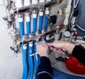 Heating engineer installing modern heating system in boiler room. Royalty Free Stock Photo