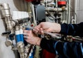 Heating engineer installing modern heating system in boiler room.