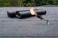 Heating and melting bitumen roofing felt Flat roof installation Royalty Free Stock Photo