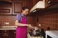 Heating and melting chocolate in a water bath before tempering it for preparing hand made chocolate desserts Royalty Free Stock Photo