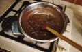 Heating and melting chocolate in a water bath before tempering it for preparing handmade chocolate desserts Royalty Free Stock Photo