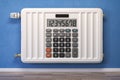 Heating radiator in form of calculator. Saving in heating, calculation energy costs and energy crisis concept