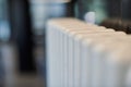 Heating radiator in office, close up. White heat exchangers. Iron aluminium steam radiator. Pipe pattern Royalty Free Stock Photo