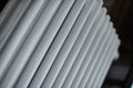 Heating radiator in office, close up. White heat exchangers. Iron aluminium steam radiator. Pipe pattern Royalty Free Stock Photo