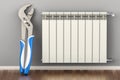 Heating radiator with radiator thermostatic valve with pipe wrench in interior. Repair and service of heating, concept. 3D Royalty Free Stock Photo