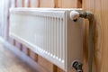 White modern radiator  on wooden wall in house with cozy interior Royalty Free Stock Photo