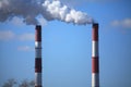 Smoking chimneys on the winter sky background