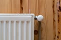 Modern individual radiator in room with wooden wall and cozy interior Royalty Free Stock Photo