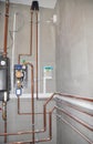 Heating system with copper pipes, copper tubing, heat pump, and control panel in a boiler room Royalty Free Stock Photo