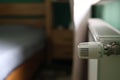 Regulator of heating system radiator in the bedroom Royalty Free Stock Photo