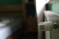 Regulator of heating system radiator in the bedroom Royalty Free Stock Photo