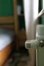 Regulator of heating system radiator in the bedroom Royalty Free Stock Photo