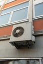 Heatpump, airconditioner hanging on outside wall of residential building, preparing for green transition