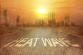 Heatwave text on the street on the city with the glowing sun background Royalty Free Stock Photo