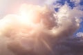 Heaven. Epic Dramatic storm cumulus clouds with yellow white sun and sunlight on blue sky background